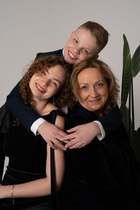 Studio family portrait of three people dressed in black