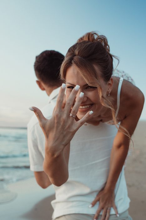 Laughing couple on a playful walk along the seashore