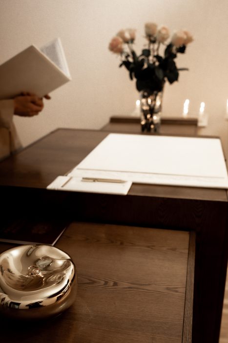 Wedding rings and the register with roses and candles at the ceremony in Jūrmala