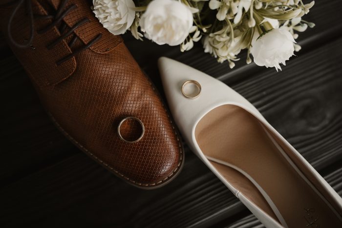 Wedding shoes, rings and a white bridal bouquet