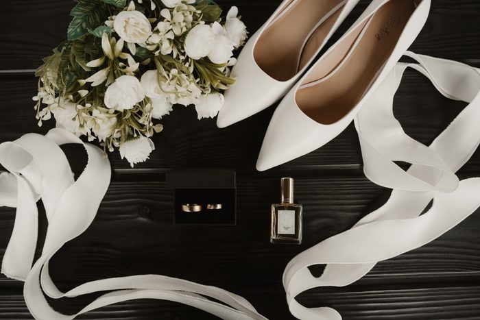 Wedding shoes, rings and a white bridal bouquet