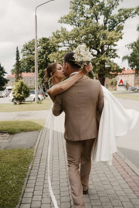 Newlyweds walking along a city street