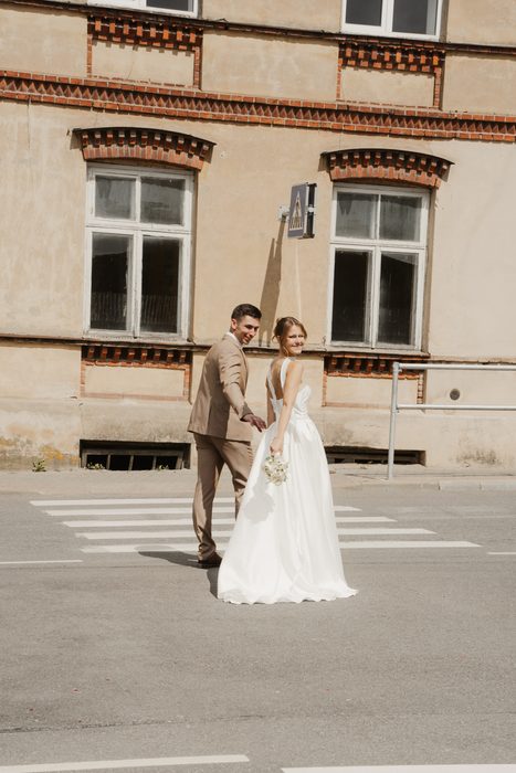 Newlyweds walking along a city street
