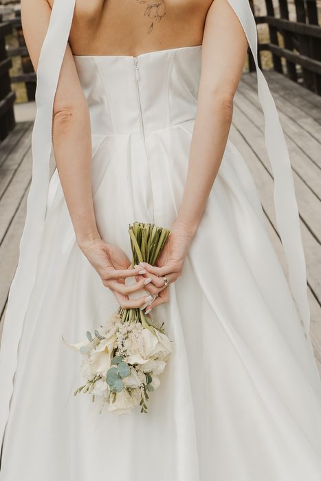 Wedding portraits on a wooden bridge beside castle walls