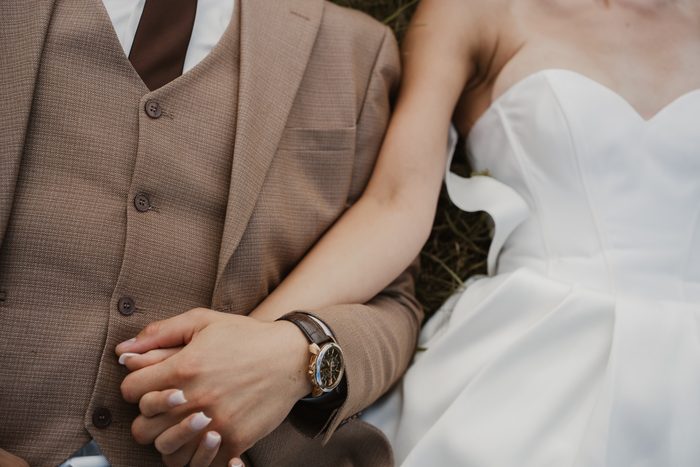 Close-up of newlyweds’ hands and rings