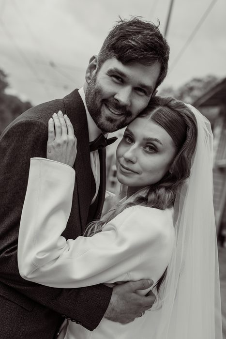 Black and white embrace, the couple looking at the camera on the Ķemeri outing