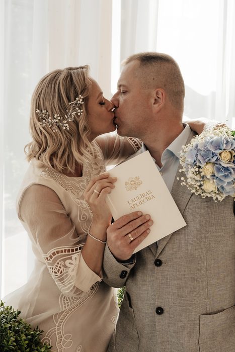 Newlyweds after the ceremony with a blue and white bouquet