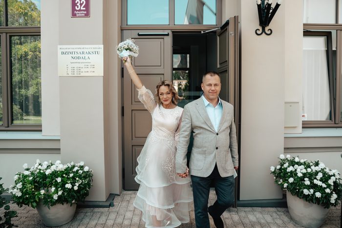 Newlyweds after the ceremony with a blue and white bouquet