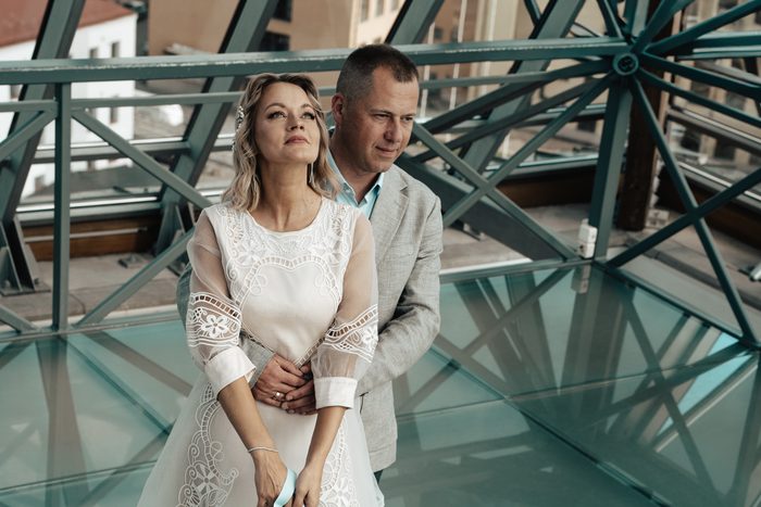 Wedding portraits beside tall windows and metal railings