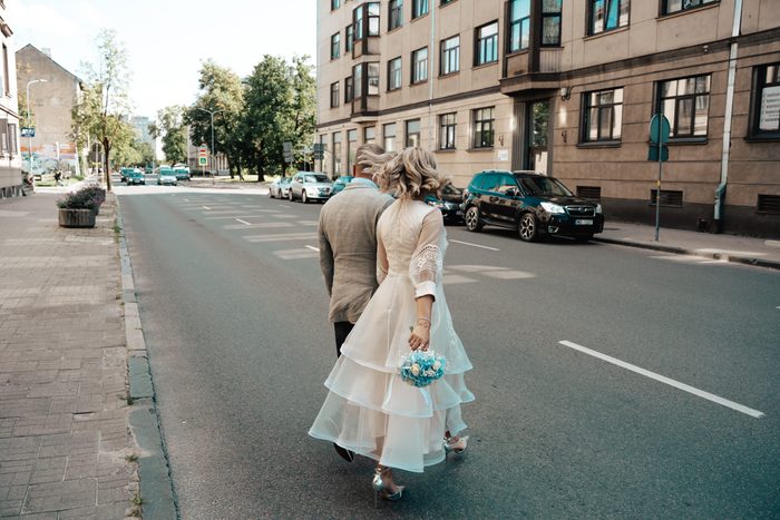 Newlyweds walking along a city street