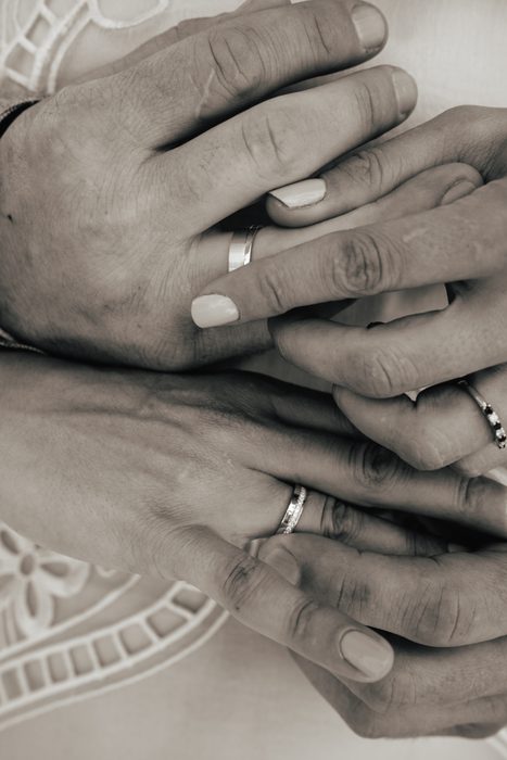 Close-up of newlyweds’ hands and rings