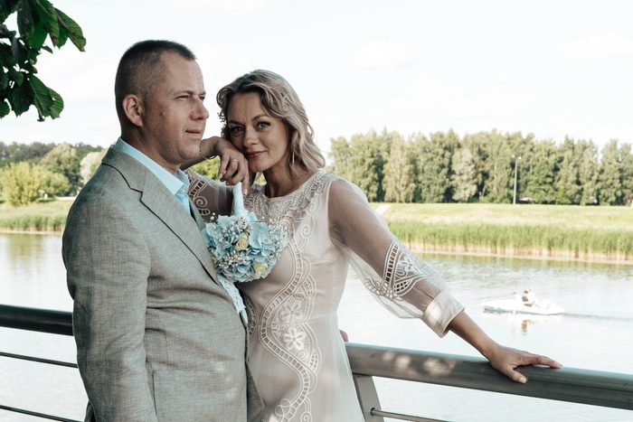 Newlywed portrait beside the water and wooden railings