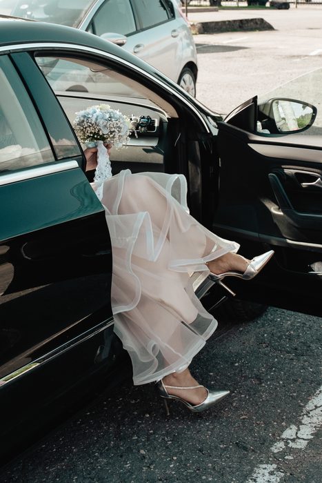 Bride stepping out of a car