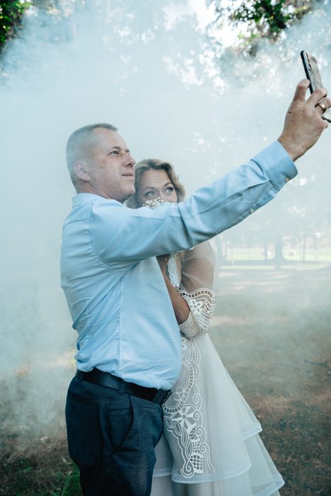 Wedding couple taking a selfie together